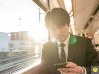 電車の中でスマホで記事を読む人